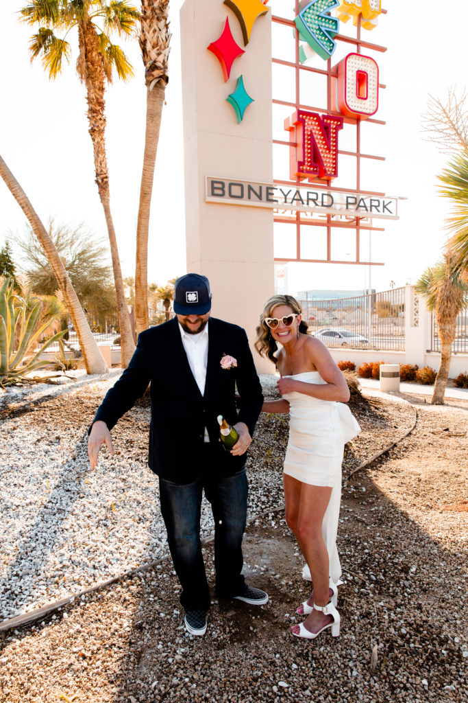 A bride and groom popping champagne in Las Vegas