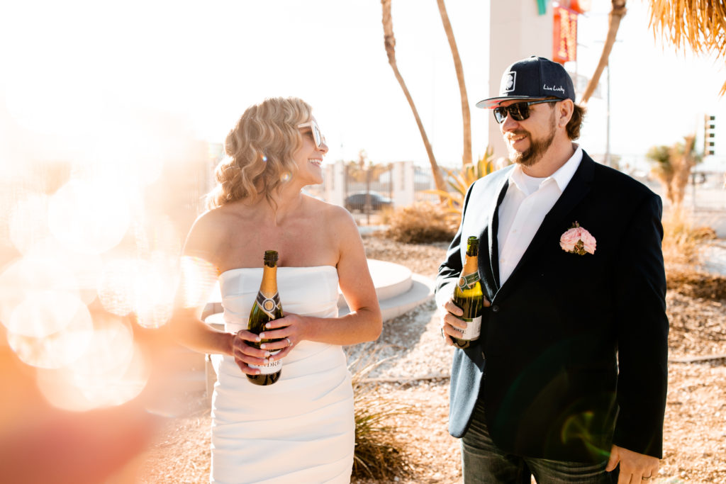 A bride and groom celebrating with champagne after their elopement