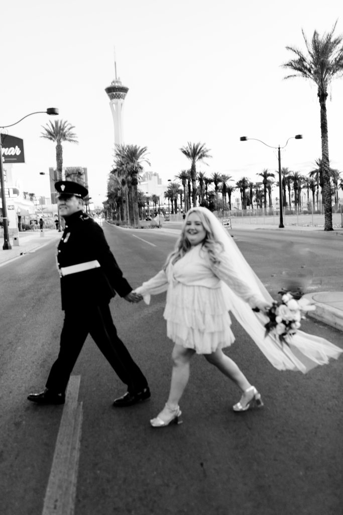 A couple walking across the street in Downtown Las Vegas after their elopement.