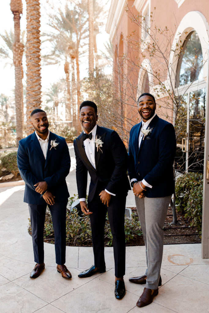 Groom and groomsman wear dark blue for this Las Vegas Wedding at the JW Marriott