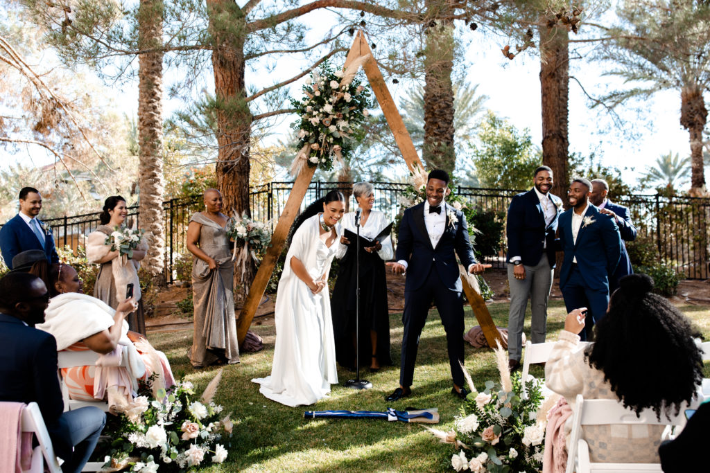 Jumping the broom tradition at this intimate wedding ceremony