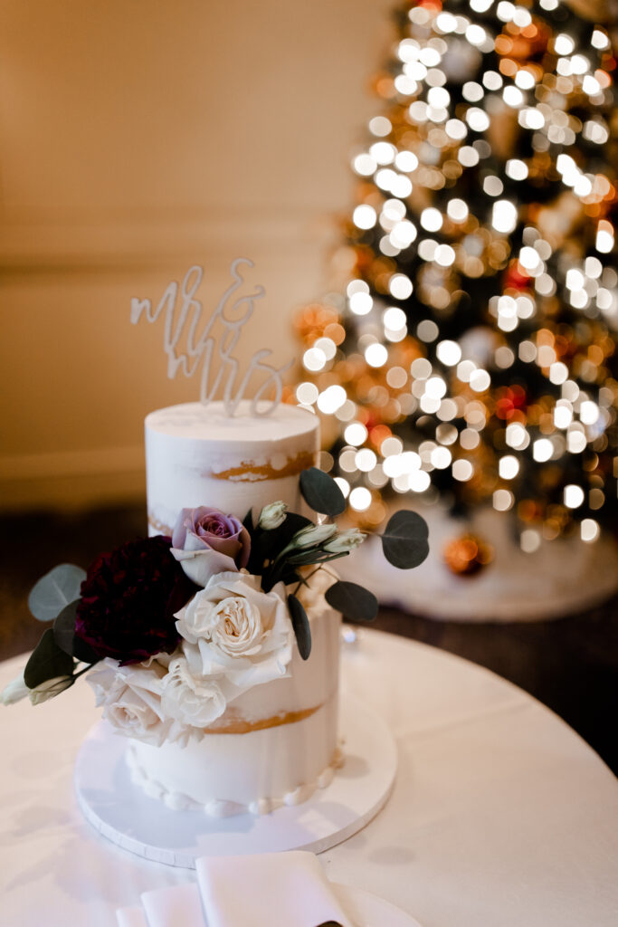 White naked wedding cake for this Christmas ballroom wedding reception.