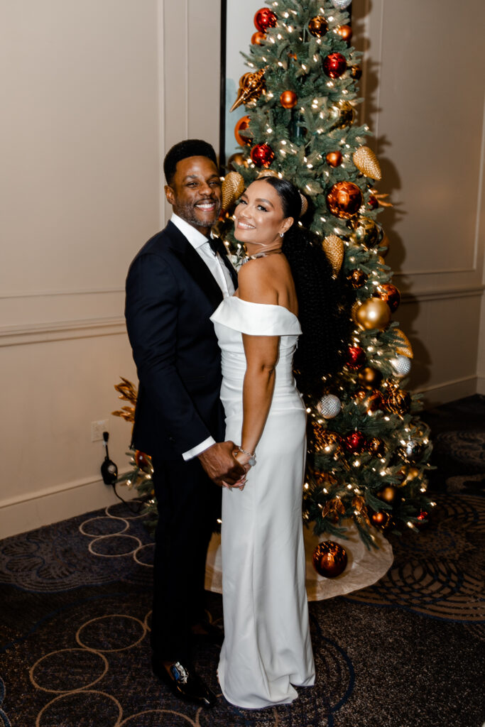 Bride and groom at their wedding reception with Christmas decor