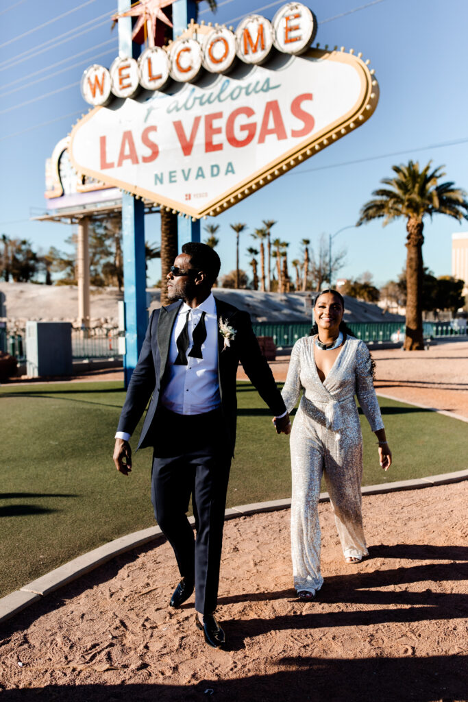 Bride and groom celebrating at the welcome to Las Vegas sign