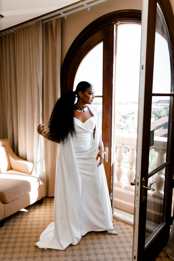 Bride with long cape wedding dress and ponytail at this JW Marriott Las Vegas Wedding