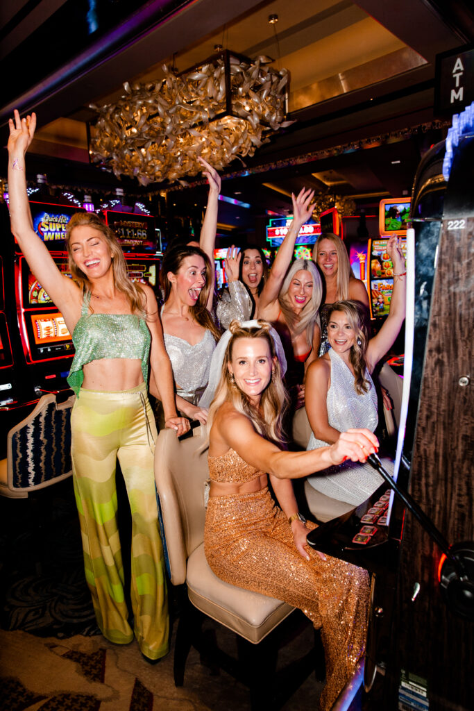 A Las Vegas bachelorette party playing slots together at the cosmopolitan resort