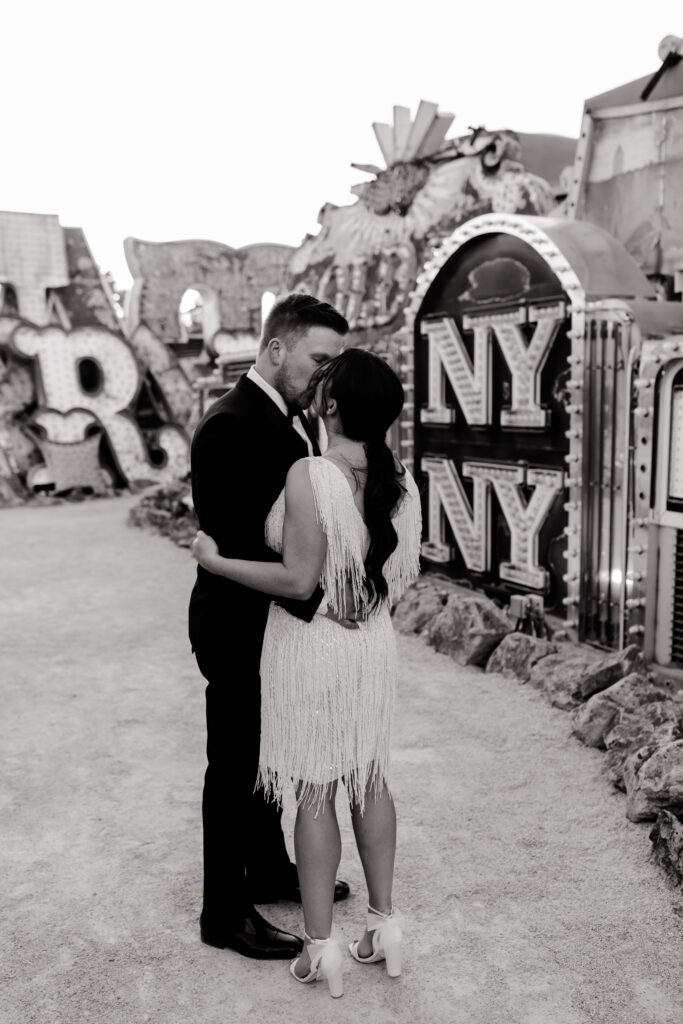 Las Vegas wedding photographer capturing couple in embrace at Neon Museum