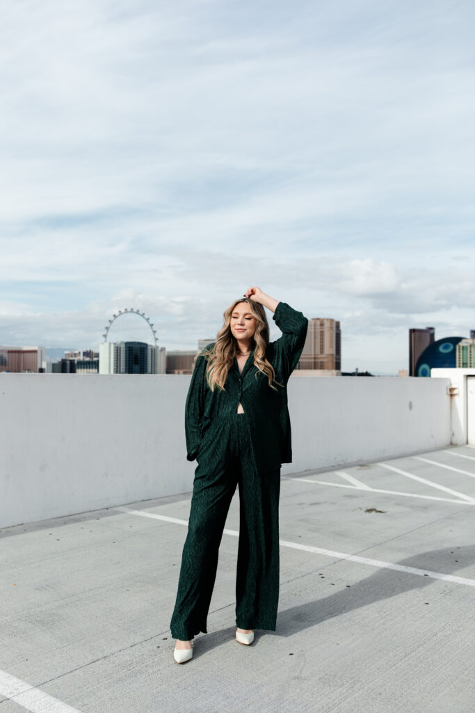 A Las Vegas wedding photographer poses for a professional portrait with the iconic Las Vegas skyline in the background, showcasing their expertise and location.