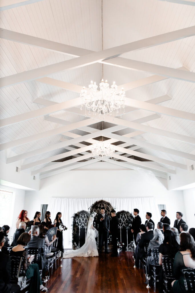 Las Vegas wedding photographer captures The bride and groom exchange vows at the altar of the Sonic Temple, surrounded by the venue's unique decor.