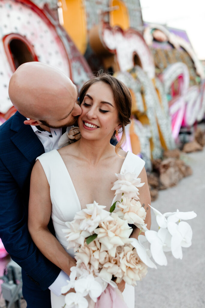 Las Vegas wedding photographer captures couple surrounded by iconic neon signs