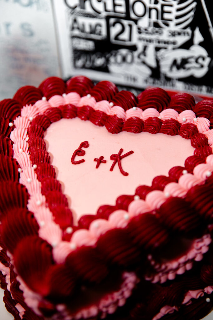 A pink and red heart shaped wedding cake