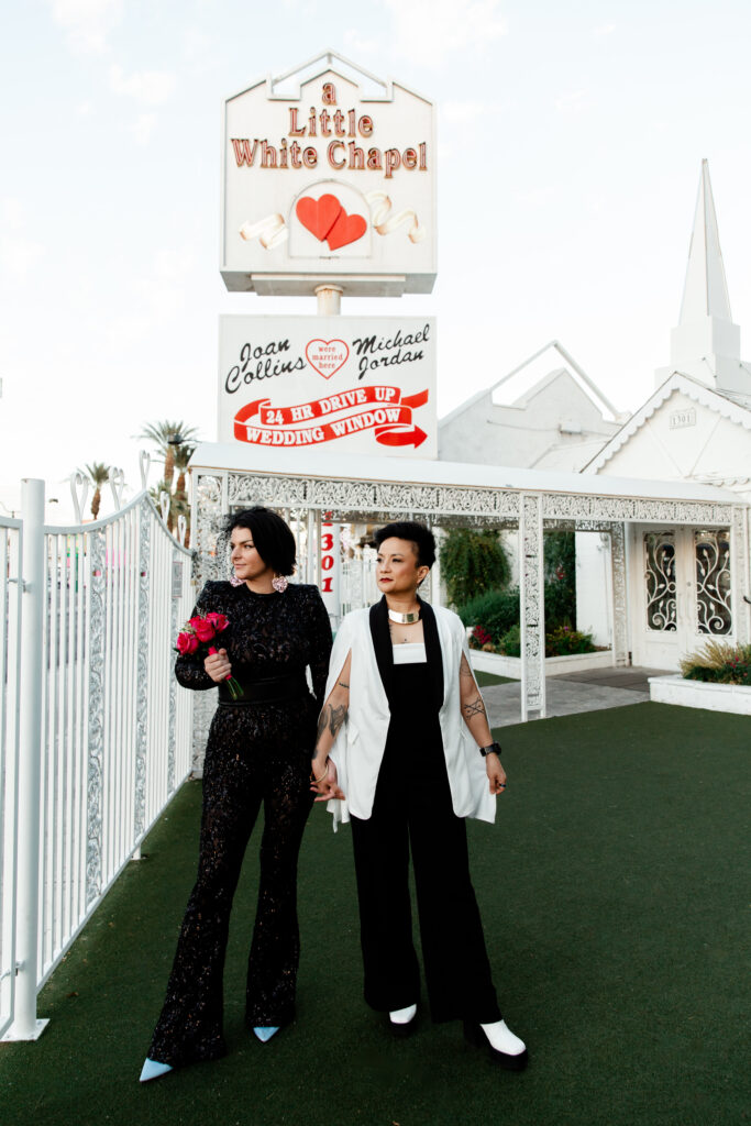 Couple posing outside A Little White Chapel at sunset