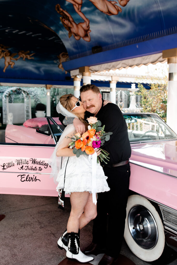 Bride and groom kissing outside A Little White Chapel in Las Vegas