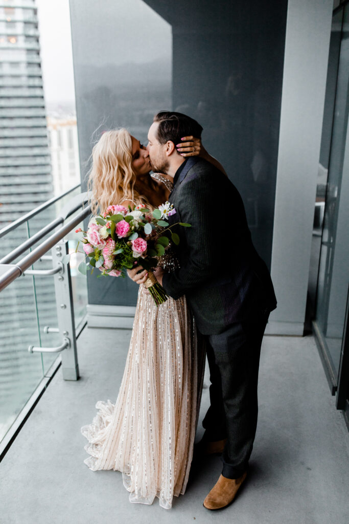 Las Vegas Photographer captures The bride and groom share their first kiss as husband and wife on the balcony of their Cosmopolitan suite