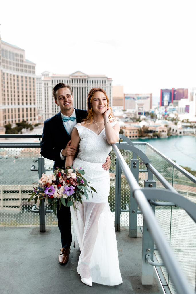 Las Vegas Photographer captures The bride and groom stand on the balcony of their Cosmopolitan suite, overlooking the stunning Las Vegas skyline.