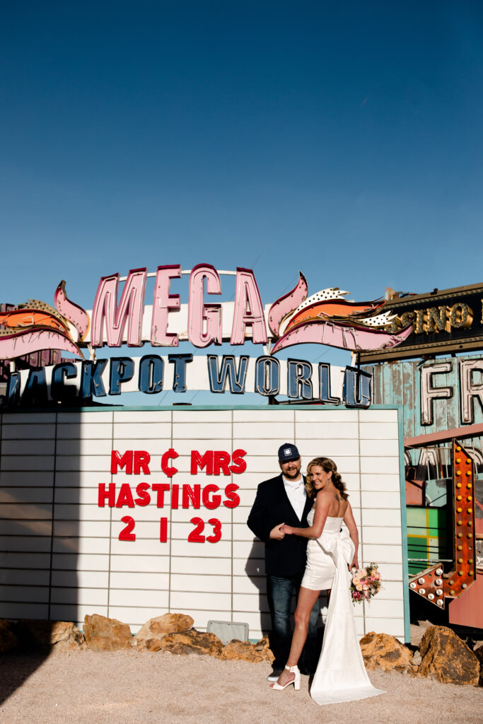 bride and groom in colorful neon art installation