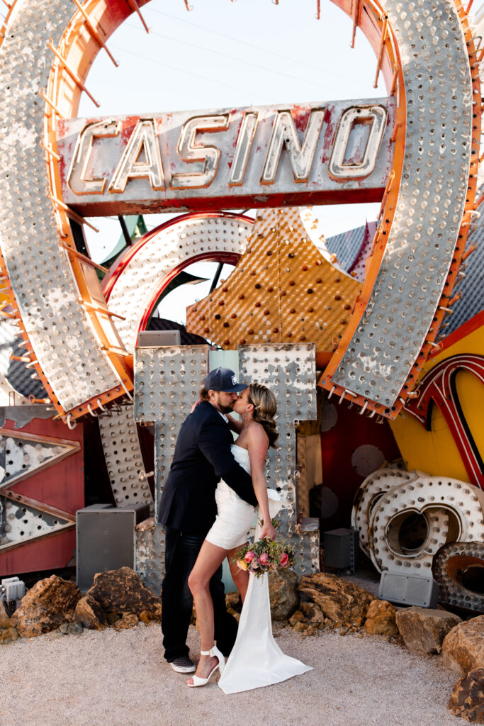 couple embracing under signs at Neon Museum