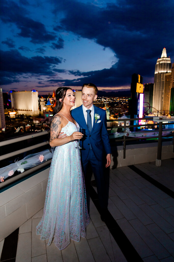 The bride delivers a heartfelt speech on the terrace of the MGM Grand suite, addressing her guests with the city's lights shimmering in the background.