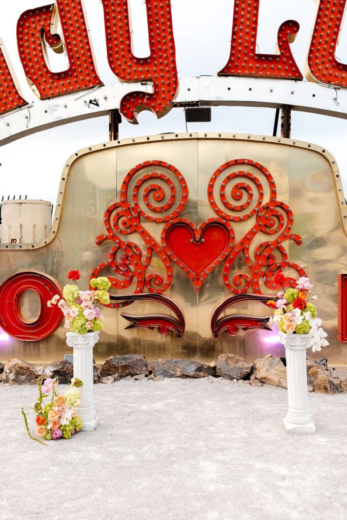 Colorful Neon Museum wedding ceremony décor with florals by Lucid Juliet