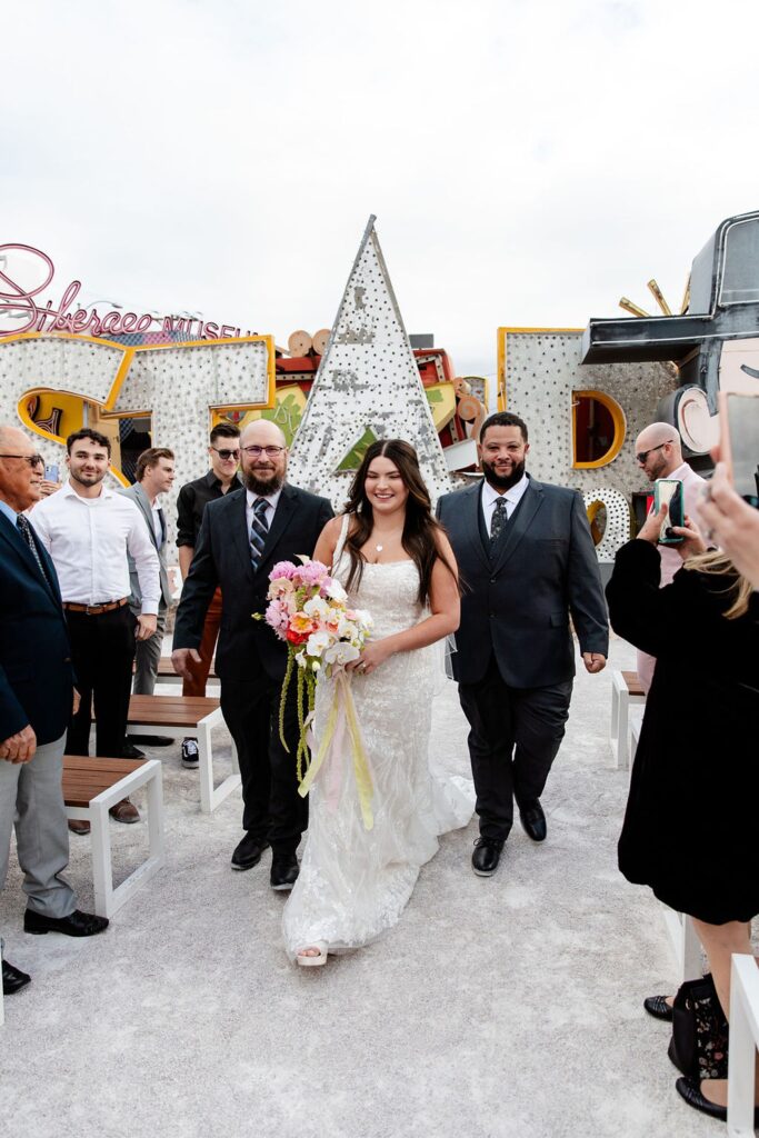 Bride walking down the aisle for her Neon Museum wedding ceremony in Las Vegas