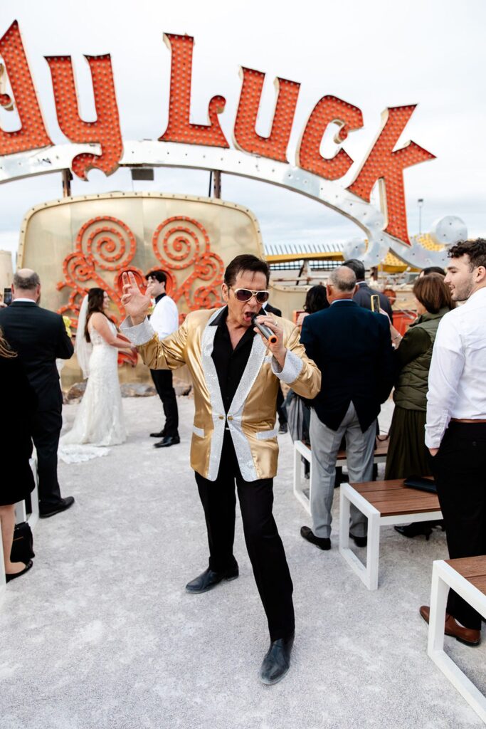 Bride and grooms Neon Museum wedding ceremony with Elvis officiant