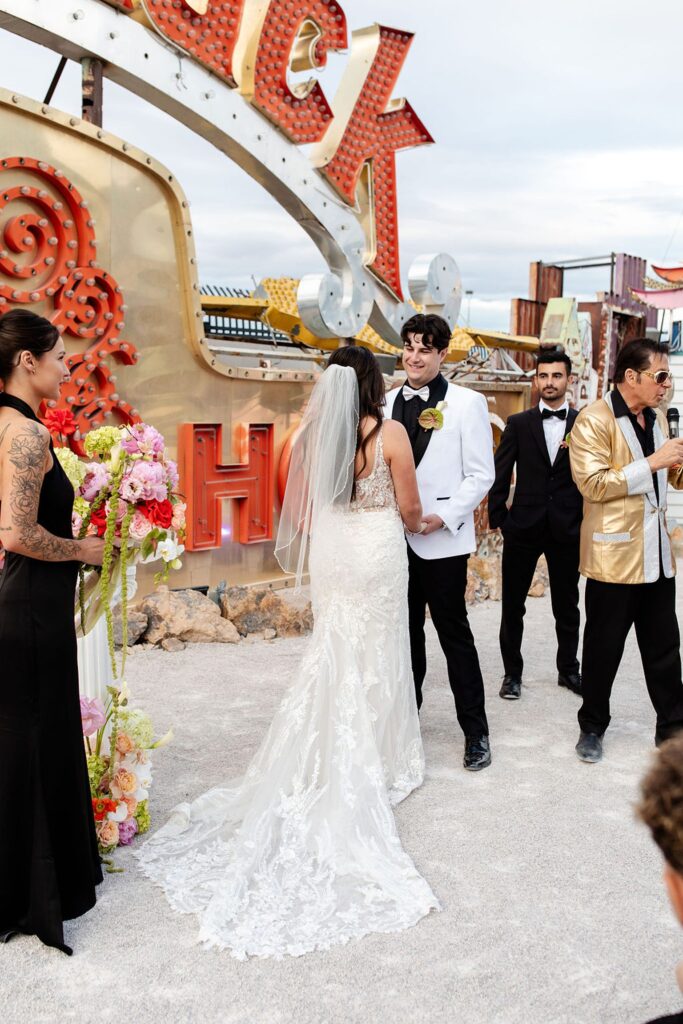 Bride and grooms Neon Museum wedding ceremony with Elvis officiant