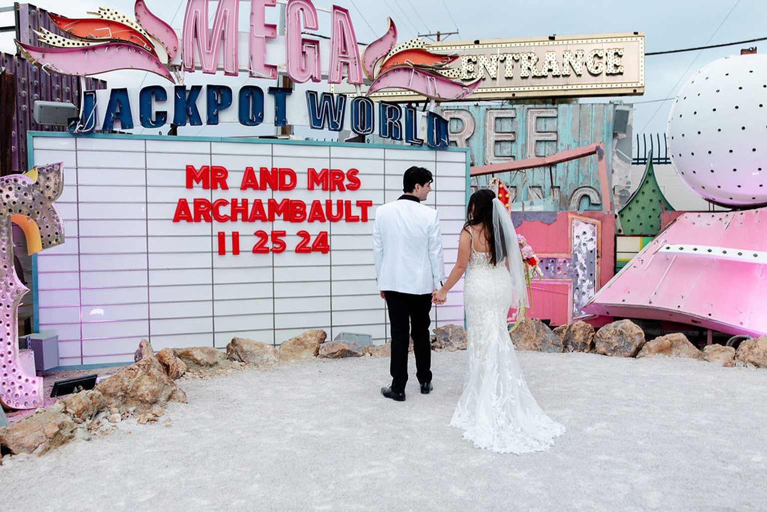 Bride and groom admiring their custom marquee sign from during their Neon Museum wedding photos in Las Vegas