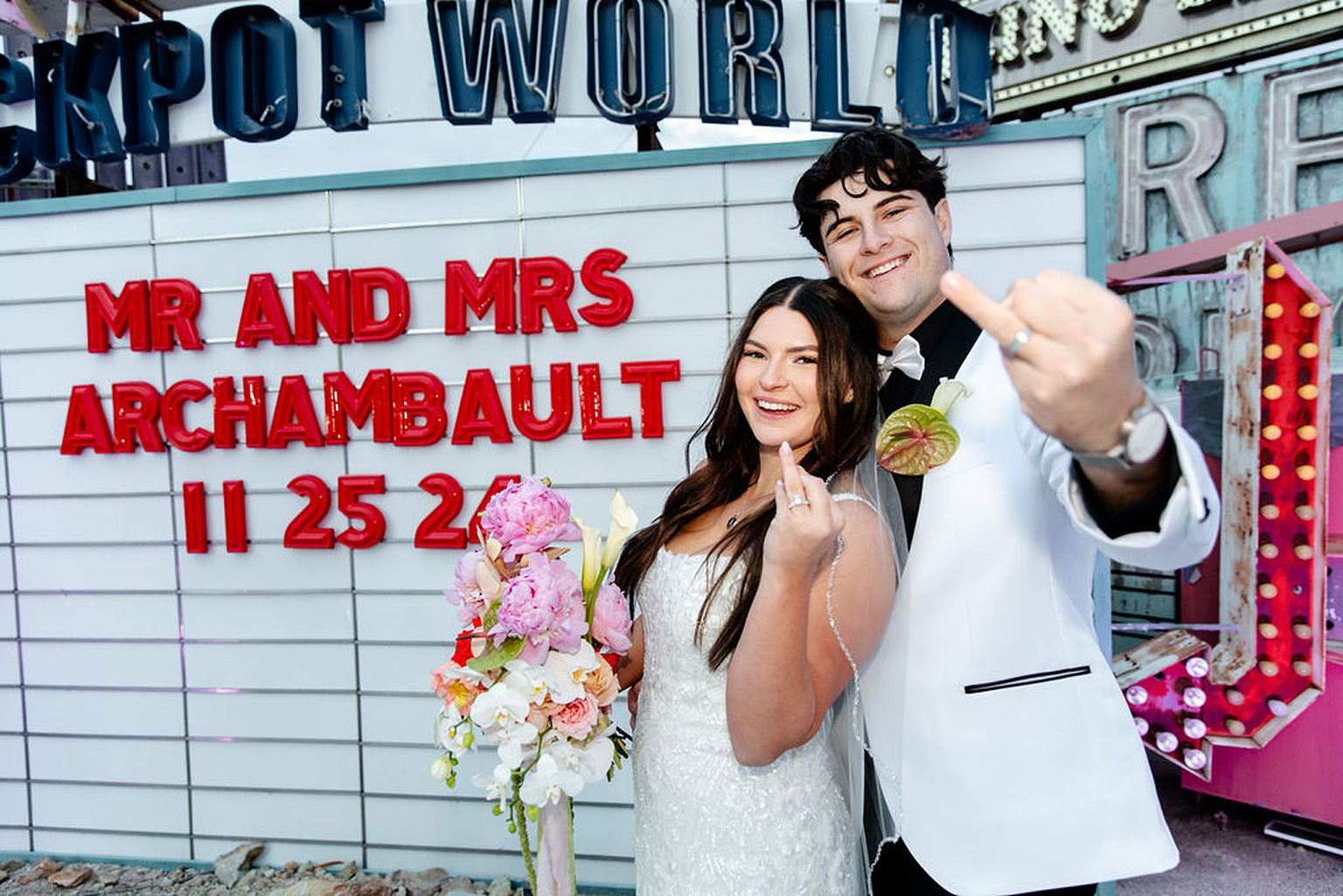 Bride and groom posing for their Neon Museum wedding portraits in Las Vegas