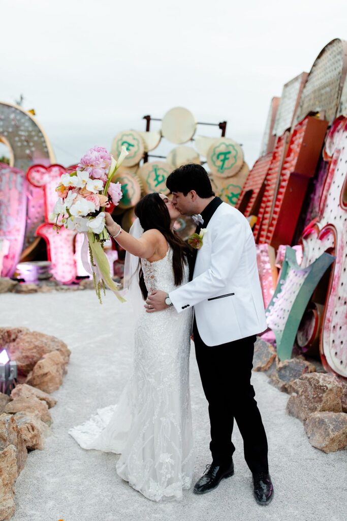 Bride and groom kissing during their Neon Museum wedding photos in Las Vegas