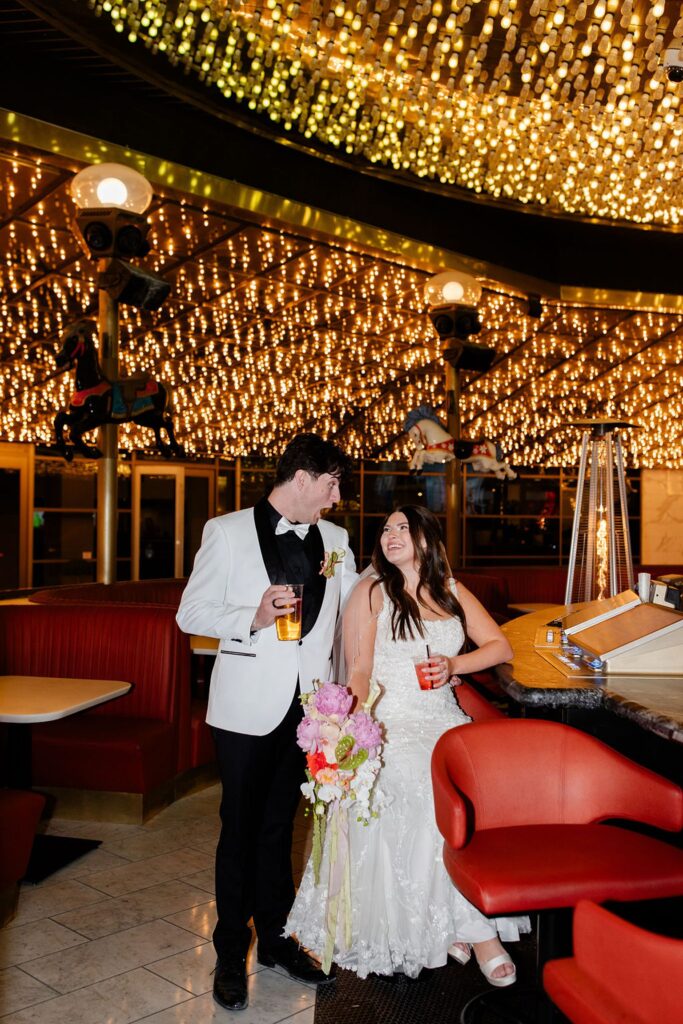 Bride and groom getting drinks at Carousel Bar on Fremont Street in Las Vegas