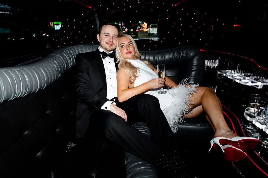 Couple posing in a limo for their engagement photos in Las Vegas