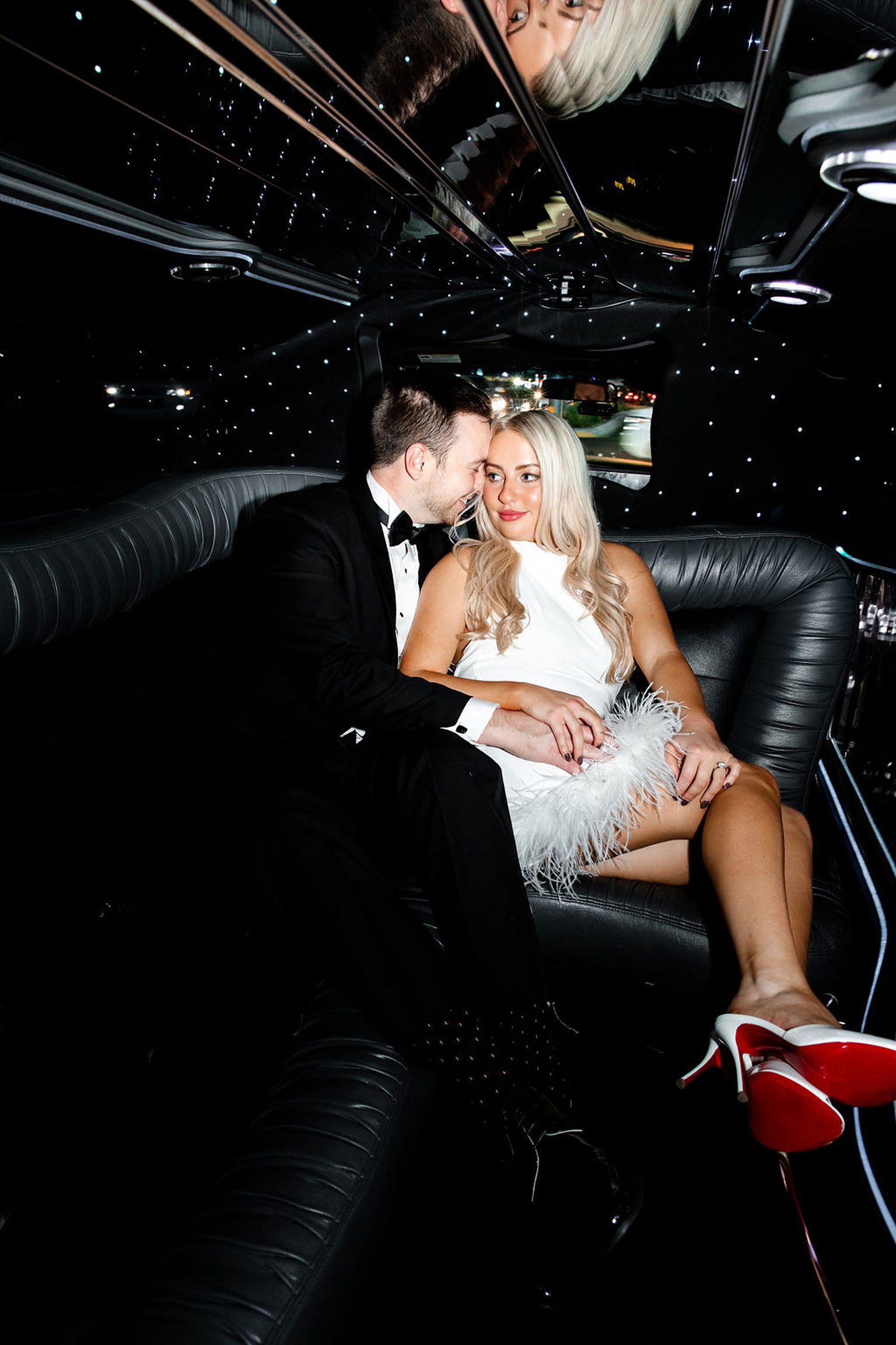 Couple posing in a limo for their timeless engagement photos in Las Vegas