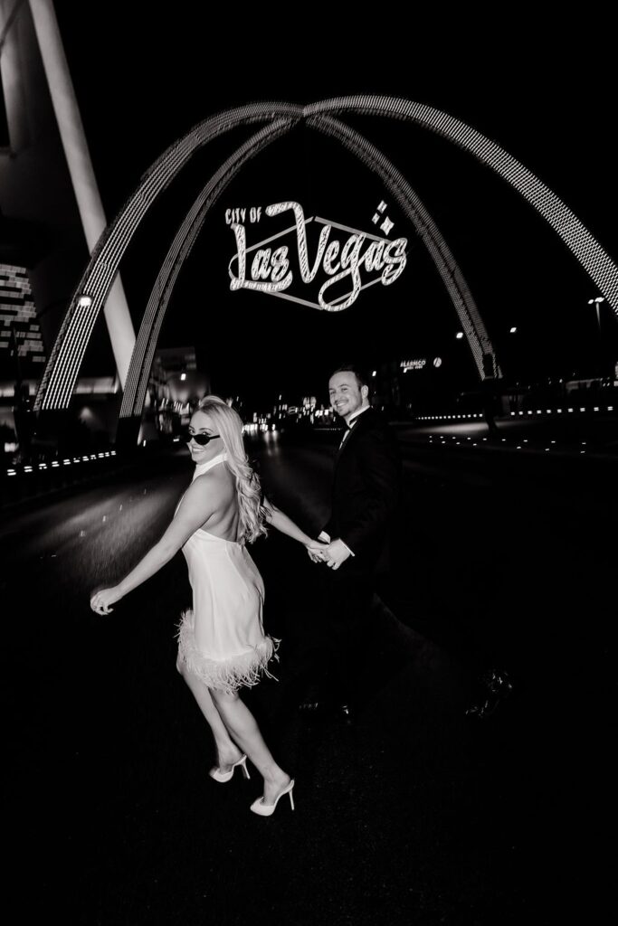 Black and white downtown engagement photos in Las Vegas un front of the city of Las Vegas sign