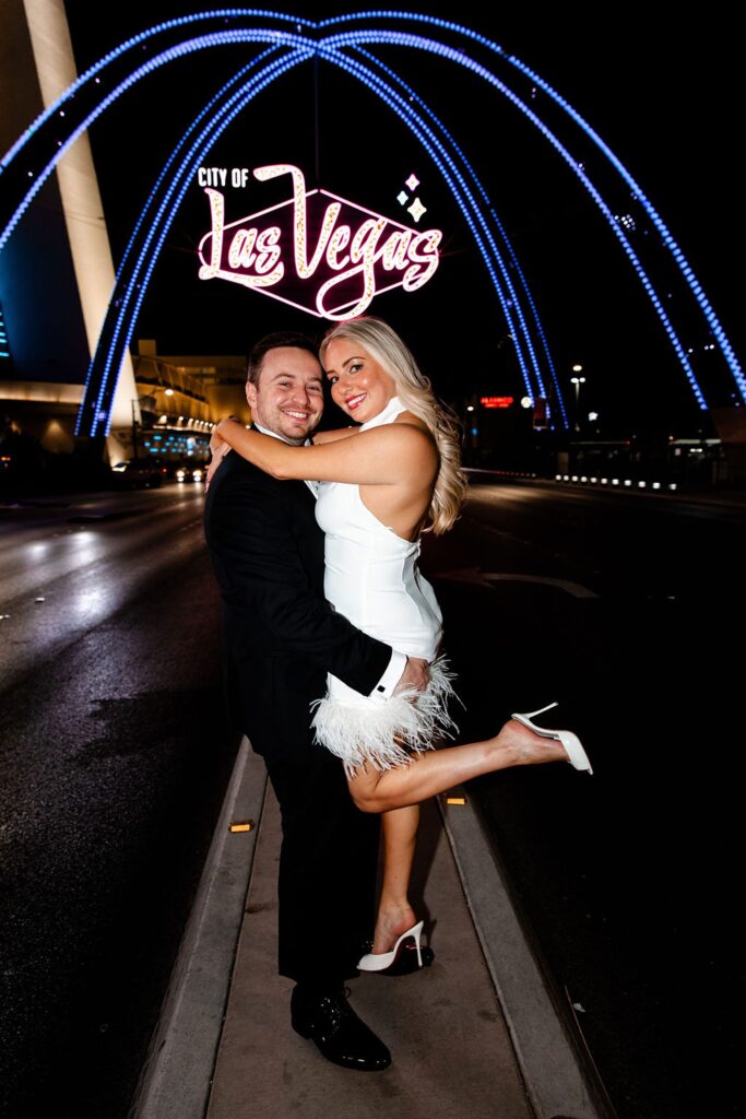 Couples Las Vegas engagement photos in front of the city of Las Vegas sign