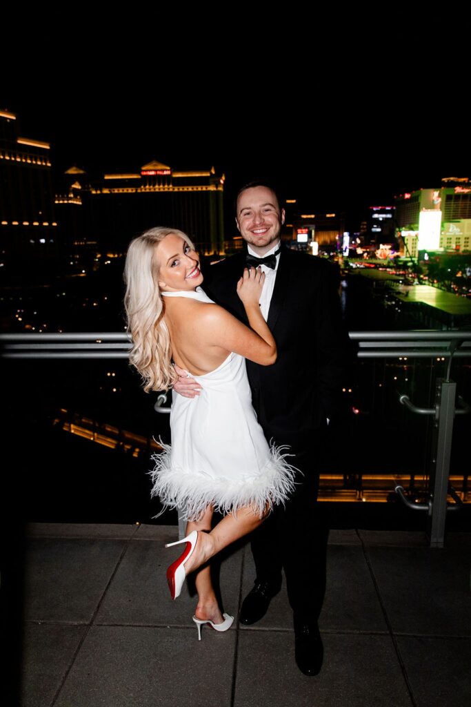 Couple posing on the balcony at The Cosmopolitan for their engagement photos in Las Vegas