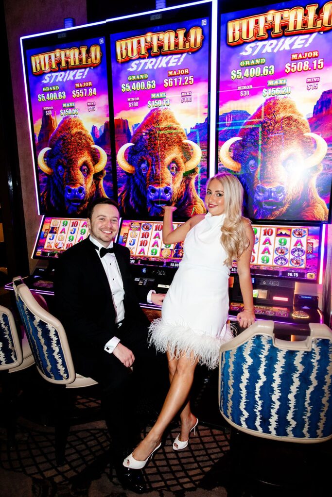 Couple posing at the slots for their Las Vegas engagement photos