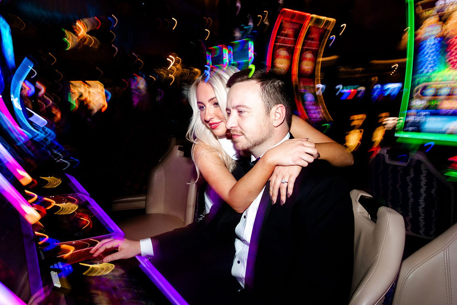 Couple playing the slots during their engagement photos in Las Vegas