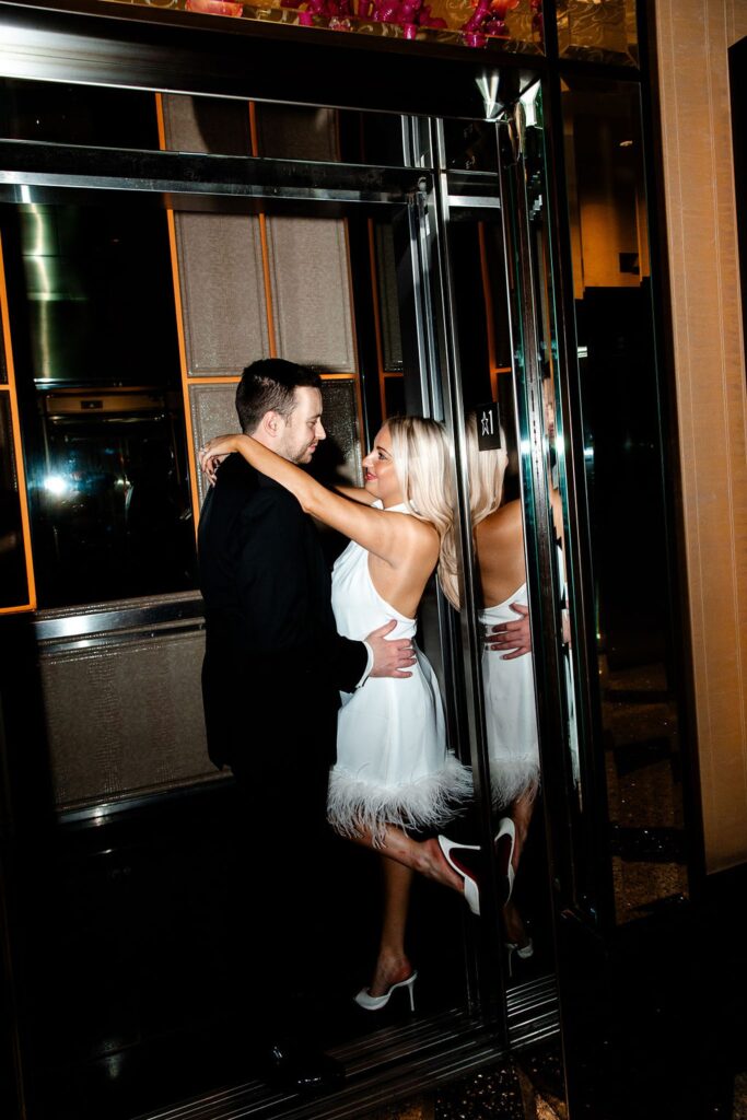 Couple posing in an elevator at The Cosmopolitan 