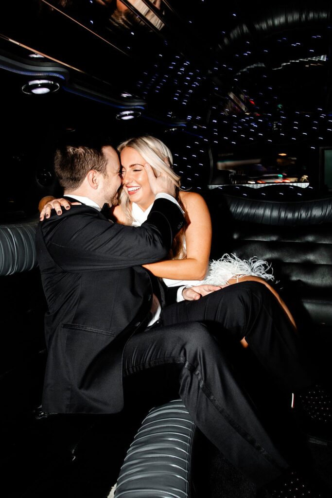 Couple getting cozy in a limo for their engagement photos in Las Vegas