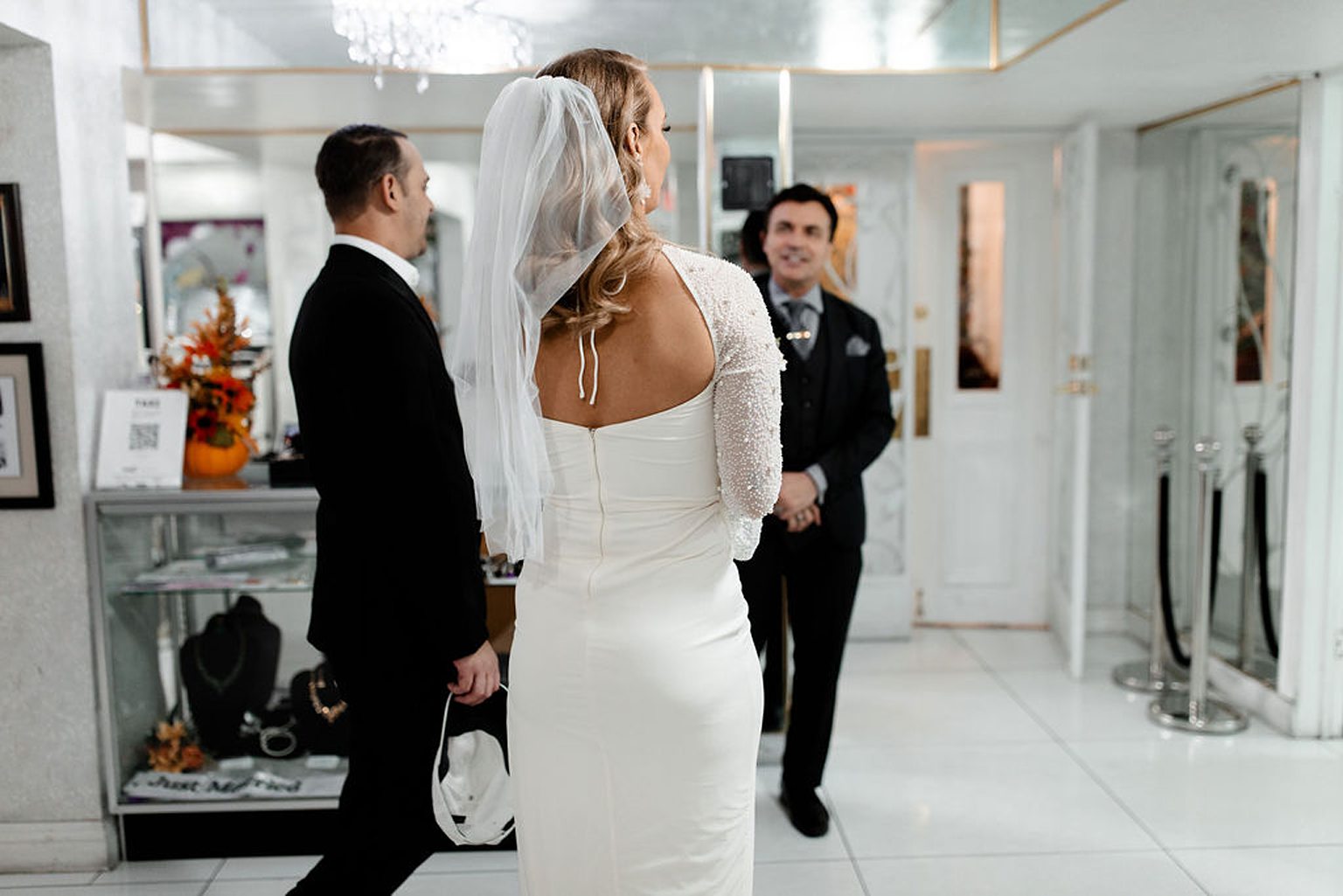 Bride and groom speaking with their minister before their ceremony