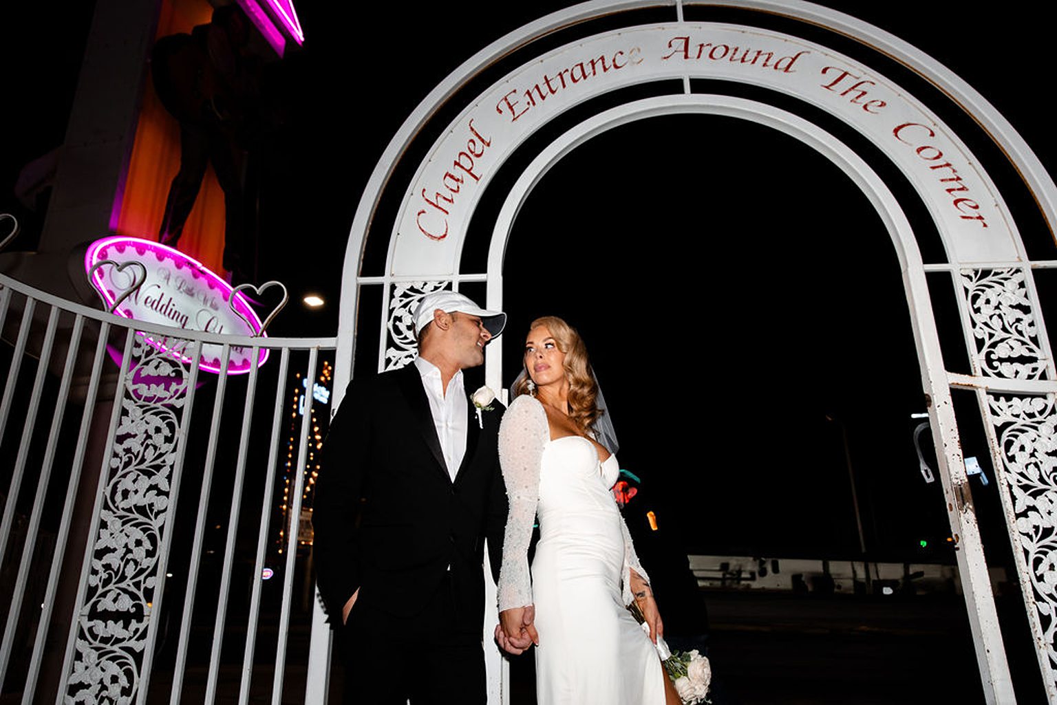 Editorial Las Vegas elopement photo of a couple posing outside of The Little White Wedding Chapel Las Vegas