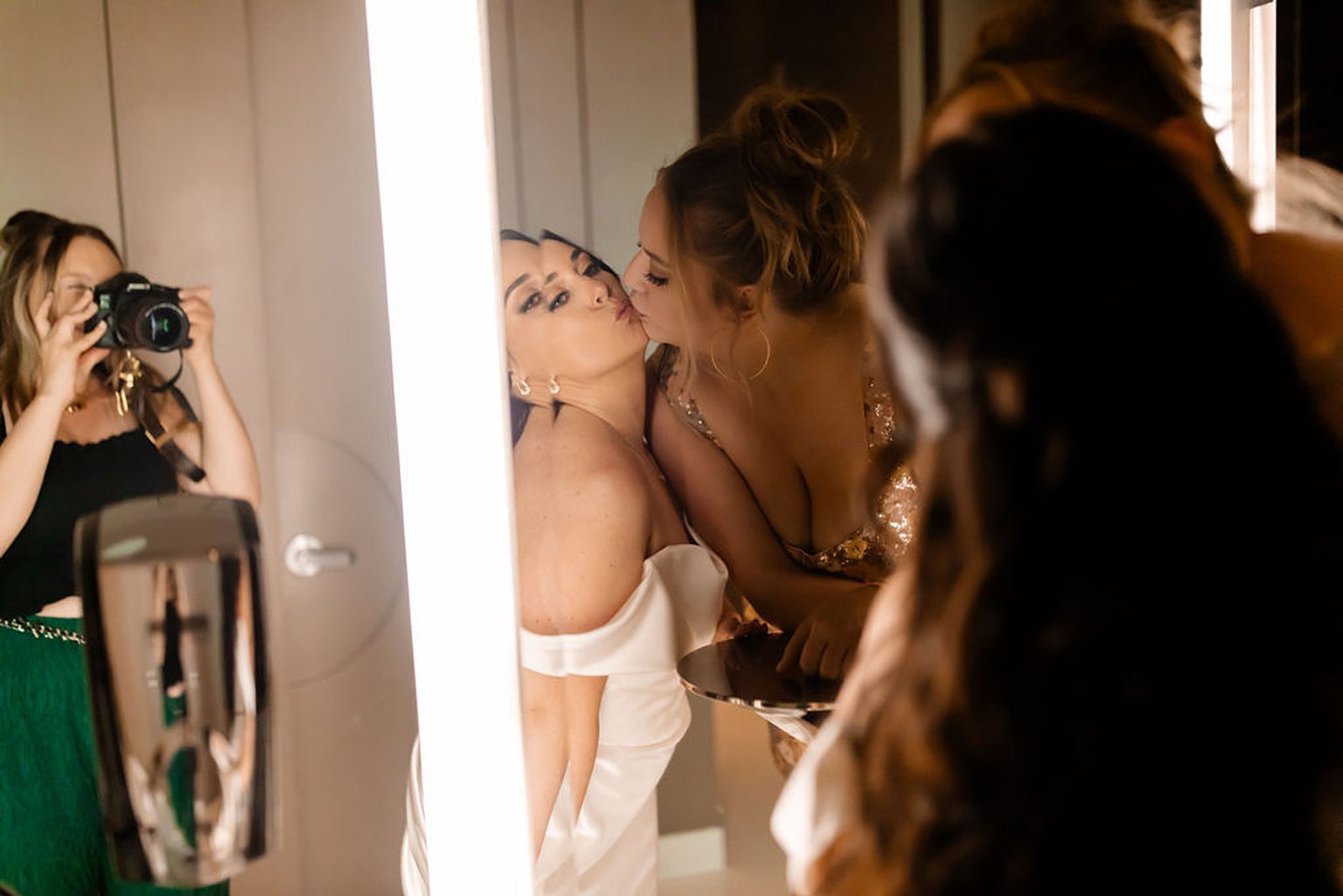 Bride and friend posing in a mirror