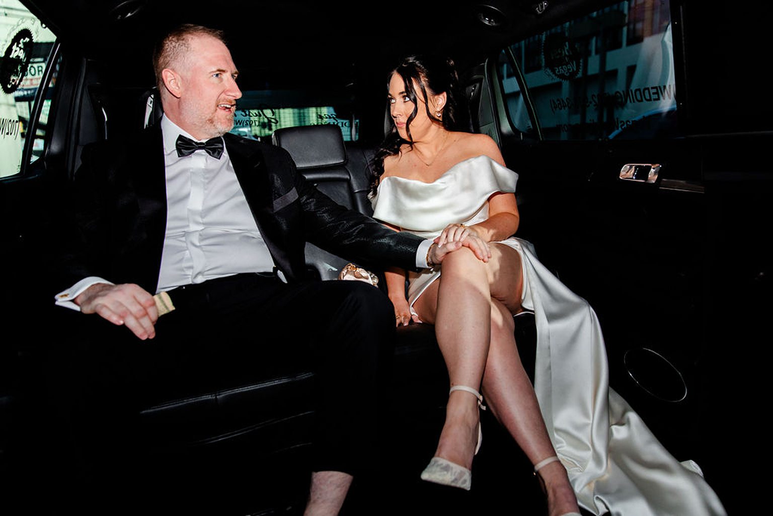 Bride and groom riding in a limo together
