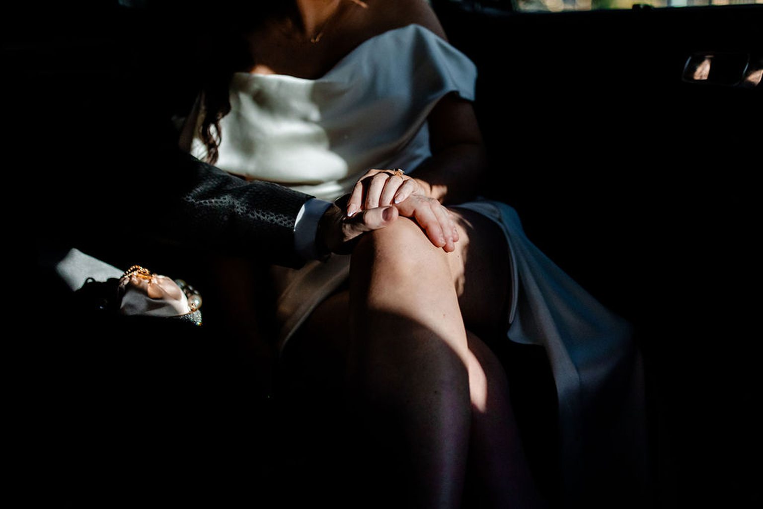 Bride and groom riding in a limo together