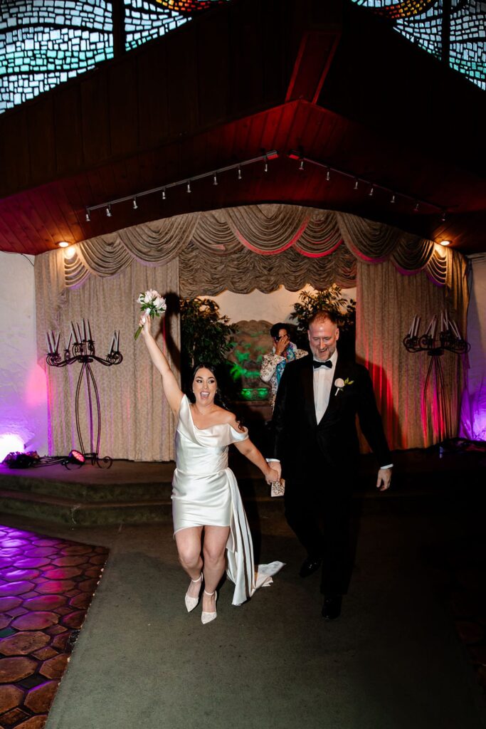 Bride and groom walking back down the aisle as husband and wife