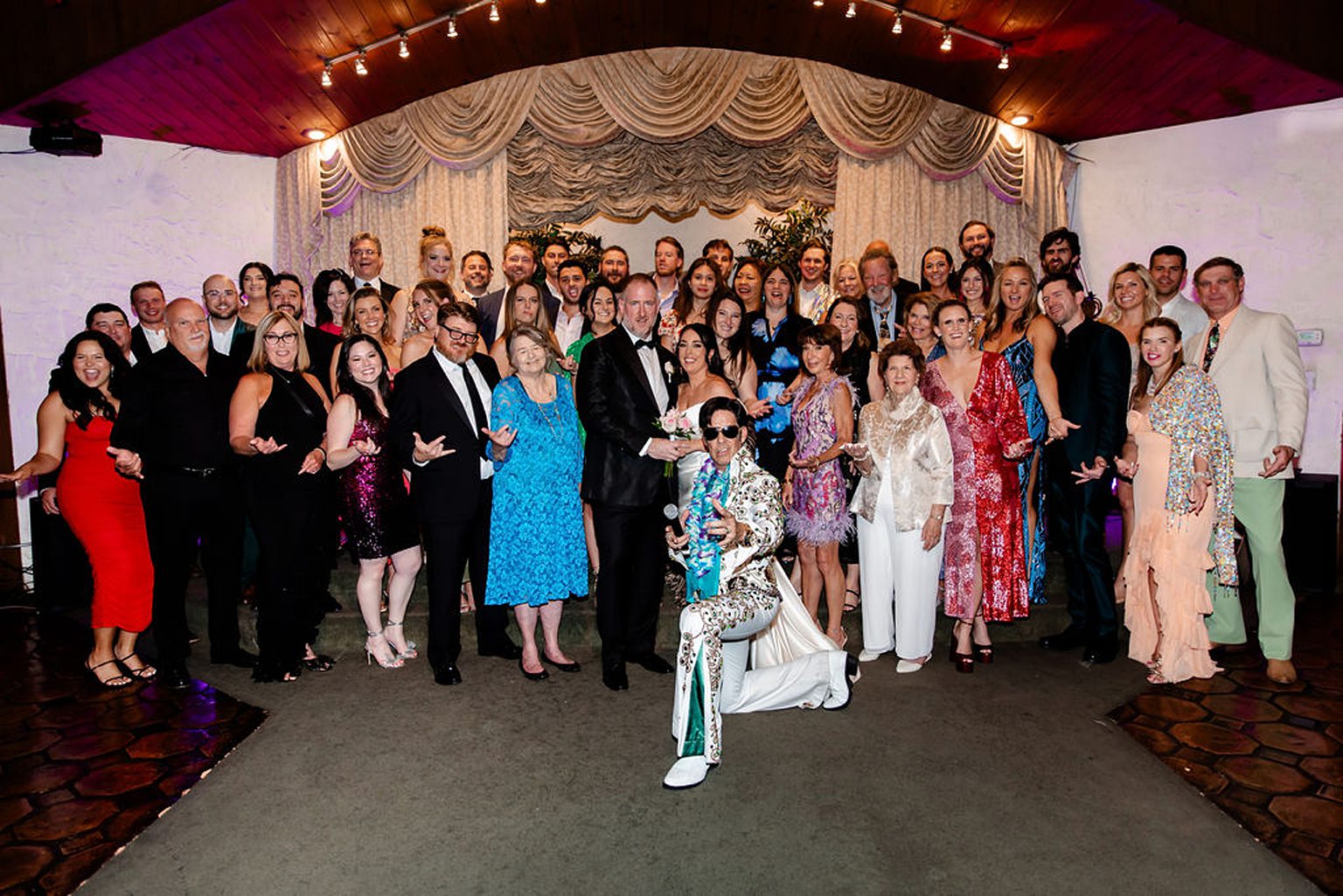 Full Las Vegas wedding weekend group shot at Viva Las Vegas wedding Chapel with Elvis