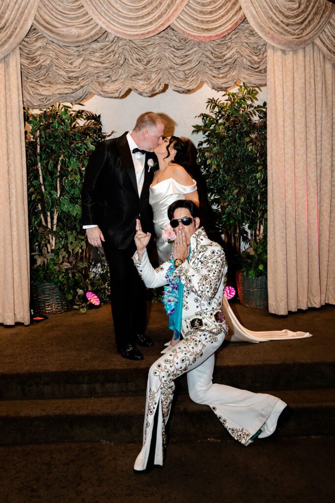 Bride and groom posing with Elvis after their Viva Las Vegas wedding ceremony