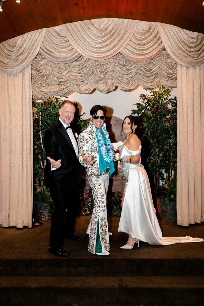 Bride and groom posing with Elvis after their Viva Las Vegas wedding ceremony