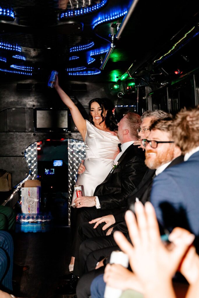 Bride and groom having fun on a party bus