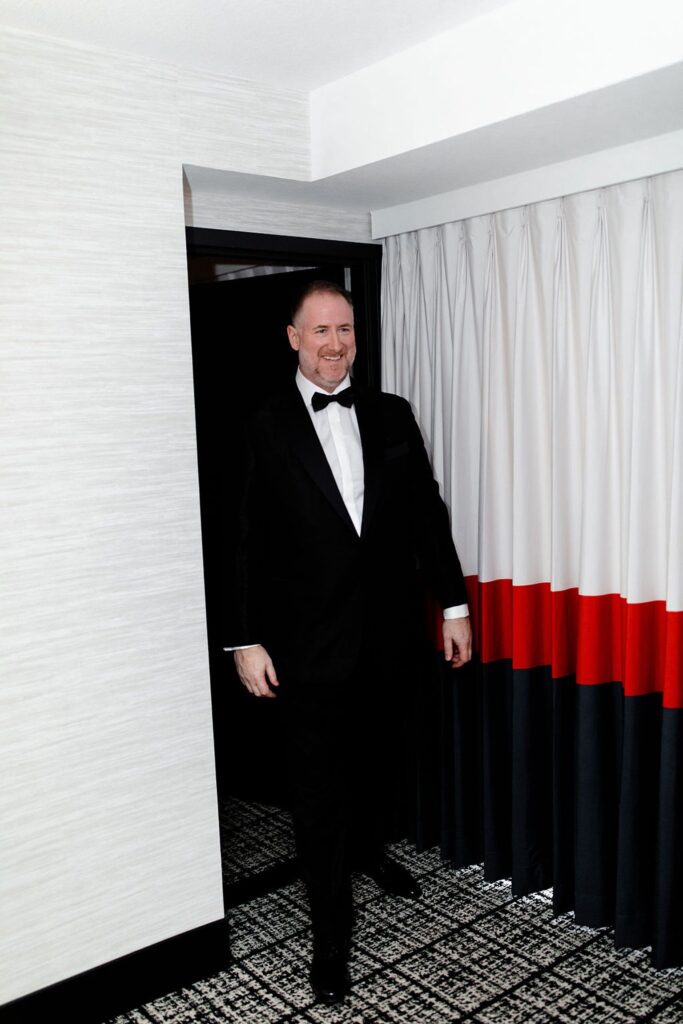 Groom walking in to share a first look with his bride to be